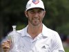 Dustin Johnson poses with his trophy after winning the St. Jude Classic golf tournament Sunday, June 10, 2012, in Memphis, Tenn. Johnson won the tournament at 9 under par. (AP Photo/Mark Humphrey)