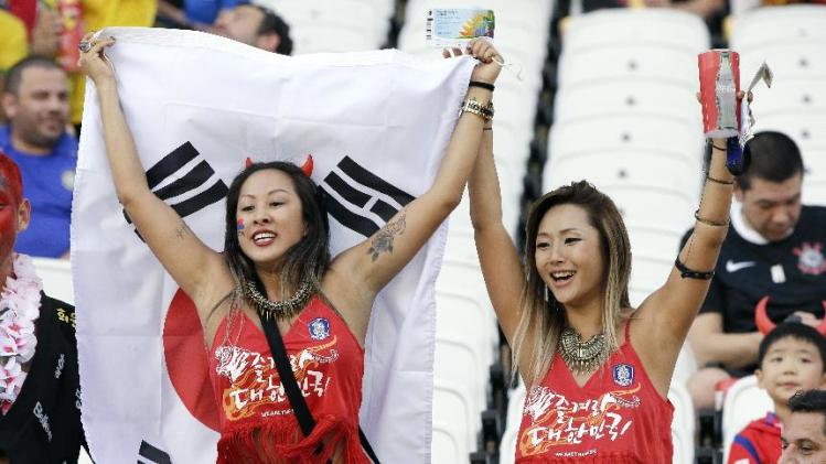South Korea fans hold a flag as they cheer prior to the group H World Cup soccer match between South Korea and Belgium at the Itaquerao Stadium in Sao Paulo, Brazil, Thursday, June 26, 2014