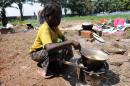 A child cooks in the catholic youth centre Don Bosco in Bangui on December 14, 2013, where thousands of people have taken refuge from sectarian violence