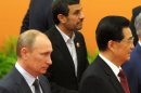 (L-R) Russian President Vladimir Putin, Iranian President Mahmoud Ahmadinejad and Chinese President Hu Jintao