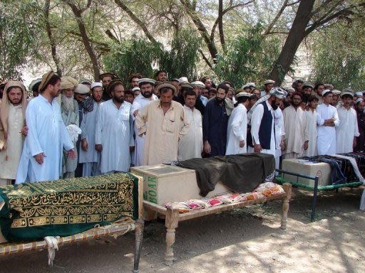 Locals gather by the coffins of people allegedly killed in a drone attack in 2011 in North Waziristan