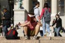 Student reads on the campus of Columbia University in New York