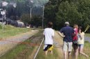 Family watches the scene of an explosion by the track that leads to derailed trains in Lac Megantic