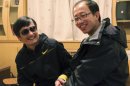 In this photo taken in late April, 2012, and provided by Hu Jia, blind Chinese legal activist Chen Guangcheng, left, meets with Hu at an undisclosed location. Chen, an inspirational figure in China's rights movement, slipped away from his well-guarded rural village on Sunday night, April 22, 2012, and made it to a secret location in Beijing on Friday, April 27, setting off a frantic police search for him and those who helped him, activists said. (AP Photo/Courtesy of Hu Jia)
