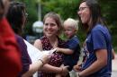 Rose Grindrod, center, gets married to Meghan Hamilton, as she hold their son Harry Hamilton, outside the City-County Building the day after the ban on same-sex marriage was struck down in Wisconsin, in Madison, Wis., Saturday, June 7, 2014. Dozens of gay couples married Saturday at courthouses in Milwaukee and Madison, taking advantage of what most believed would be a small window in which to get hitched before a judge's decision overturning the state's same-sex marriage ban was put on hold. (AP Photo/Wisconsin State Journal, Amber Arnold)
