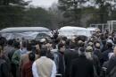 The remains of shooting victims are carried away after a service in a soccer field near the Islamic Association of Raleigh February 12, 2015, in Raleigh, North Carolina