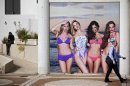 An Israeli walks past an advertising displayed on a main street in Tel Aviv, Israel, on Monday, March 19, 2012. A new Israeli law, passed late Monday, is trying to fight the spread of eating disorders by banning underweight models from local advertising. (AP Photo/Oded Balilty)