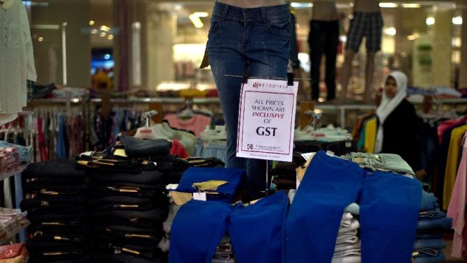 A signboard notifies customers of the six-percent goods and services tax (GST) on consumer goods at a mall in Kuala Lumpur, May 9, 2015