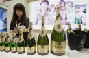 A participant looks at a bottle of German HenKell Trocken sparkling wine at a wine expo in Beijing