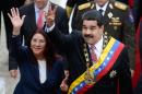 Venezuelan President Nicolas Maduro (R) and his wife Cilia Flores (L) wave upon their arrival at the National Assembly in Caracas on July 5, 2015