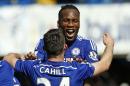 Chelsea's Didier Drogba embraces Gary Cahill as they celebrate after the English Premier League soccer match between Chelsea and Crystal Palace at Stamford Bridge stadium in London, Sunday, May 3, 2015. Chelsea won the match 1-0 to secure Premier League title with 3 games to spare. (AP Photo/Alastair Grant)