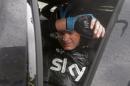 Britain's Christopher Froome gets into his team car as he abandons the race