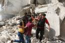 Rescuers remove a victim from the rubble of a destroyed building following a reported air strike in the Qatarji neighbourhood of the northern city of Aleppo