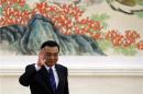 China's Premier Li Keqiang waves as he arrives for a news conference, after the closing ceremony of the Chinese National People's Congress at the Great Hall of the People, in Beijing