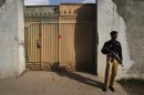 A policeman keeps guard outside the gates of the compound where al Qaeda leader Osama bin Laden was reported to have been killed in Abbottabad