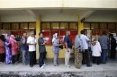 Voters queue up to cast their ballots during the general elections in Pekan