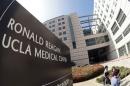 People walk past the entrance to the Ronald Reagan UCLA Medical Center in Los Angeles, California