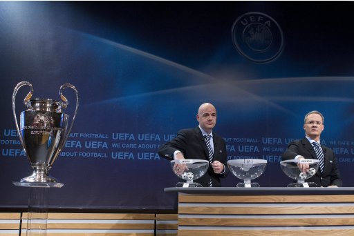 UEFA General Secretary Gianni Infantino, left, and UEFA Competitions Director, Giorgio Marchetti, right, pick up the balls containing the names of the soccer clubs, during the draw for the Champions League playoffs at the UEFA Headquarters in Nyon, Switzerland, Friday, Aug. 5, 2011. (AP Photo/Keystone, Salvatore Di Nolfi) GERMANY OUT - AUSTRIA OUT