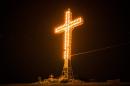 The giant, illuminated cross that hangs over Lac-Megantic is seen on July 13, 2013 in Lac-Megantic, Quebec, Canada