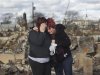 Neighbors Lucille Dwyer and Linda Strong embrace after looking through the wreckage of their homes devastated by fire and the effects of Hurricane Sandy in the Breezy Point section of the Queens borough of New York