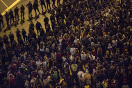 Manifestantes brasileños se congregan junto al cordón de seguridad formado por la policía alrededor del estadio Maracaná en Rio de Janeiro, el domingo, 30 de junio del 2013. (Foto AP/Felipe Dana)