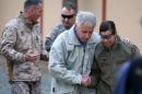 U.S. Secretary of Defense Chuck Hagel, center is greeted by military personnel after arriving at International Security Assistance Force Headquarters (ISAF) on Saturday, Dec. 7, 2013 in Kabul, Afghanistan. Secretary Hagel made a stop in Afghanistan during his six-day trip to the middle east. (AP Photo/Mark Wilson, Pool)