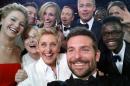 This image released by Ellen DeGeneres shows actors front row from left, Jared Leto, Jennifer Lawrence, Meryl Streep, Ellen DeGeneres, Bradley Cooper, Peter Nyong'o Jr., and, second row, from left, Channing Tatum, Julia Roberts, Kevin Spacey, Brad Pitt, Lupita Nyong'o and Angelina Jolie as they pose for a "selfie" portrait on a cell phone during the Oscars at the Dolby Theatre on Sunday, March 2, 2014, in Los Angeles. (AP Photo/Ellen DeGeneres)