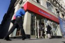 People pass a Bank of America brach, in New York, Monday, Jan. 7, 2013. Bank of America will pay $10.3 billion to the government mortgage agency Fannie Mae to settle claims resulting from mortgage-backed investments that soured during the housing crash. (AP Photo/Richard Drew)