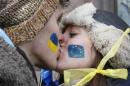 Students kiss as they stand on a street to form a human chain from the Ukrainian capital to the western border during a demonstration in Kiev