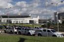Police vehicles are parked outside the headquarters of the South American soccer confederation known as CONMEBOL in Asuncion, Paraguay, Thursday, Jan. 7, 2016. Paraguayan authorities raided the CONMEBOL headquarters Thursday in connection to the sprawling FIFA probe being led by U.S. and Swiss prosecutors. (AP Photo/Cesar Olmedo)