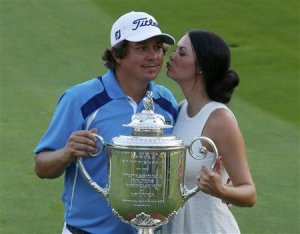 Jason Dufner of the U.S. is kissed by his wife Amanda …