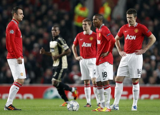 Manchester United's players react after an own goal from Jones during their Champions League soccer match against Benfica in Manchester