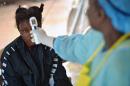 A girl suspected of being infected with the Ebola virus has her temperature checked at a government hospital in Kenema, Sierra Leone, on August 16, 2014