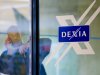 A man looks out of a door next to the Dexia logo at the corporate headquarters in Brussels on Tuesday, Oct. 4, 2011. France and Belgium were fighting to prevent Dexia from going under as investors grew increasingly worried over its ability to survive a renewed credit crunch. The two countries have promised Tuesday to prop up the bank and insure every cent of its deposits in response to a calamitous decline in the bank's share price over the past couple of days. (AP Photo/Geert Vanden Wijngaert)