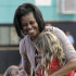 First Lady Michelle Obama laughs as she talks to two you children at the Holiday Park Gym, Wednesday, Aug. 22, 2012 in Fort Lauderdale, Fla. (AP Photo/Alan Diaz)