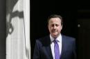Britain's Prime Minister David Cameron leaves 10 Downing Street as he names his new cabinet in central London,