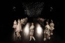 Models wear creations by British designer Sarah Burton for Alexander McQueen as part of the Fall-Winter, ready-to-wear 2013 fashion collection, during Paris Fashion week, Tuesday, March 6, 2012. (AP Photo/Christophe Ena)