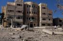 A doctor walks as he inspects the damage, after what activists said were barrel bombs dropped by forces loyal to Syria's President Bashar al-Assad, on a hospital in the city of Nawa, in Deraa province, Syria