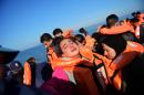 A girl cries as she arrives along with other migrants and refugees, on the Greek island of Lesbos, after crossing the Aegean Sea from Turkey, on November 18, 2015