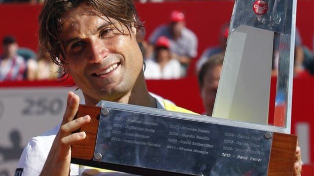Spain's David Ferrer holds the trophy after winning the Buenos Aires Open