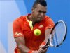 Tsonga of France returns the ball to Dodig of Croatia during their men's singles tennis match at the Queen's Club tournament in London