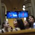 Visitors look up during a tour at the Stock Exchange in Madrid, Monday, May 28, 2012.  Shares in Spanish bank Bankia, one of the banks hardest hit by Spain's real estate collapse over the past four years, fell 28 per cent on opening in Madrid on Monday, the bank's first day back on the stock exchange following its announcement Friday that it would need Euro 19 billion ($23.8 billion) bailout to bolster its defenses.(AP Photo/Daniel Ochoa de Olza)