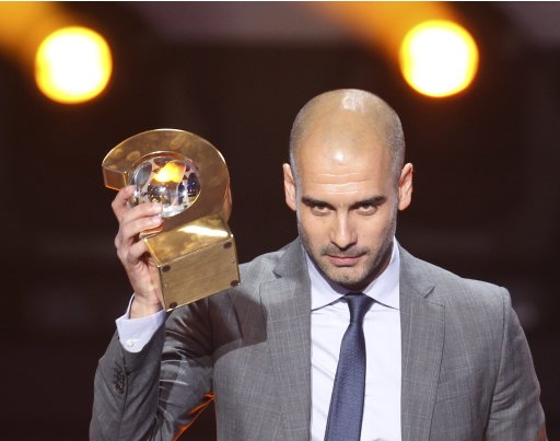 Coach of FC Barcelona Pep Guardiola is awarded the prize for the soccer coach of the year at the FIFA Ballon d'Or awarding ceremony in Zurich, Switzerland, Monday, Jan. 9, 2012. (AP Photo/Michael Probst)