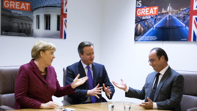 German Chancellor Angela Merkel, left, speaks with British Prime Minister David Cameron, center, and French President Francois Hollande as they meet on the sidelines of an EU summit in Brussels on Thursday, Oct. 15, 2015. (Yves Herman, Pool Photo via AP)