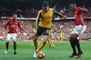 Arsenal's defender Carl Jenkinson (C) vies with Manchester United's striker Anthony Martial (R) and midfielder Juan Mata during the English Premier League football match November 19, 2016