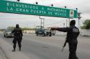 Members of the Mexican Federal police patrol the entrance road to Matamaros city on April 26, 2011 in Tamaulipas state, northern Mexico