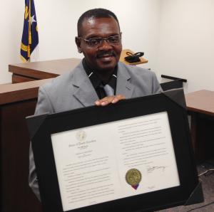 Henry McCollum holds a framed copy of his pardon before &hellip;