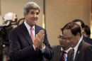 U.S. Secretary of State John Kerry gestures a greeting as he arrives to make opening remarks at the US-ASEAN Ministerial meeting, in Brunei