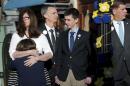 The family of Boston Marathon bombing victim Martin Richard joins Boston Mayor Marty Walsh at a ceremony at the site of the second bomb blast on the second anniversary of the bombings in Boston