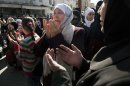 A woman weeps as she prays during an anti-government demonstration in Idlib, north Syria, Friday, March 9, 2012. (AP Photo/Rodrigo Abd)
